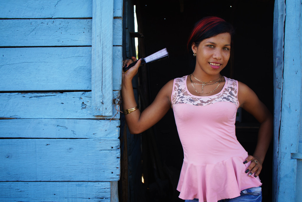 A girl poses in the doorway near a restaurant on one of the quiet roads in Eastern Cuba. Photographed on a Tamron 35mm f/1.8 at 1/200, f/3.5.