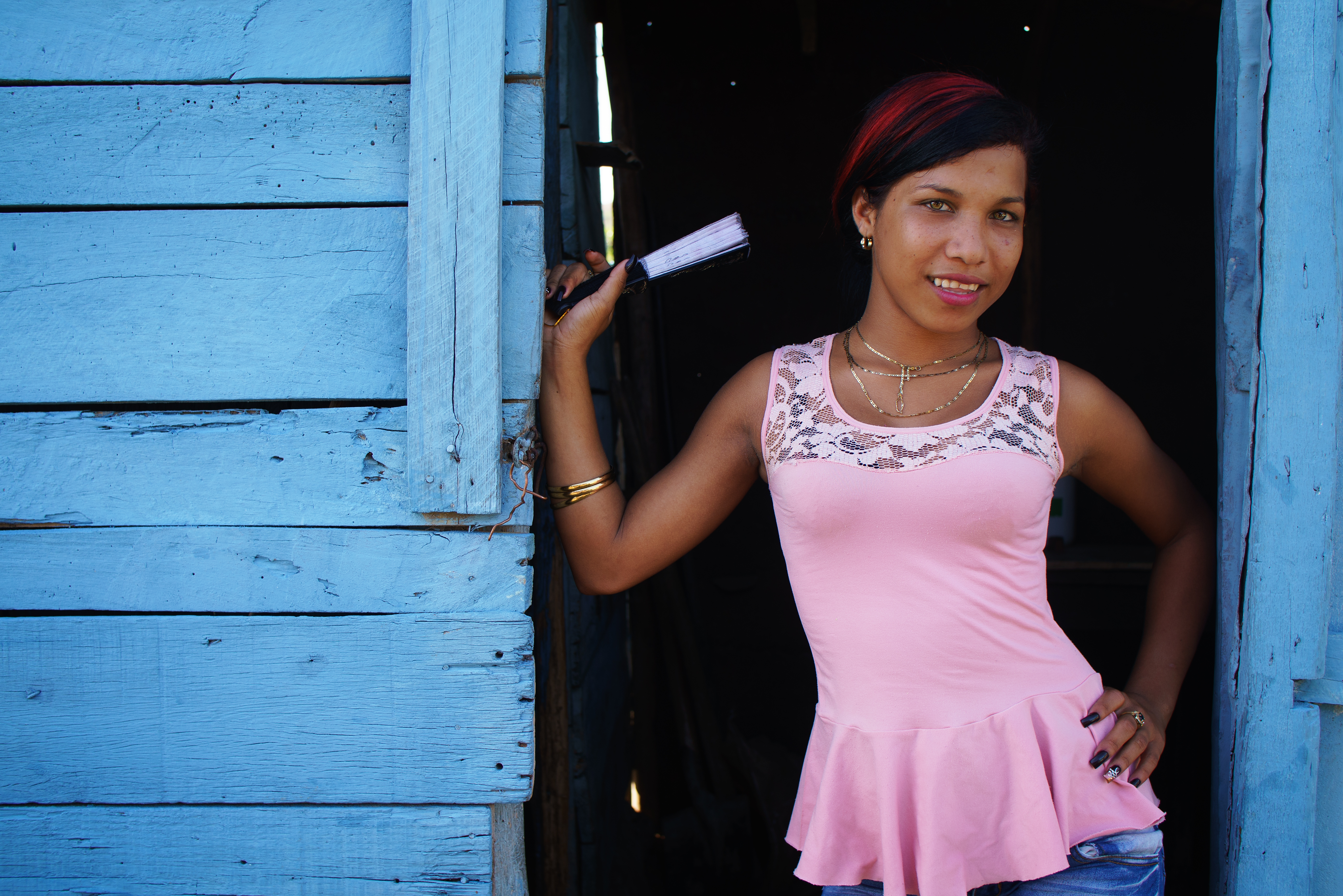 A girl poses in the doorway near a restaurant on one of the quiet roads in ...