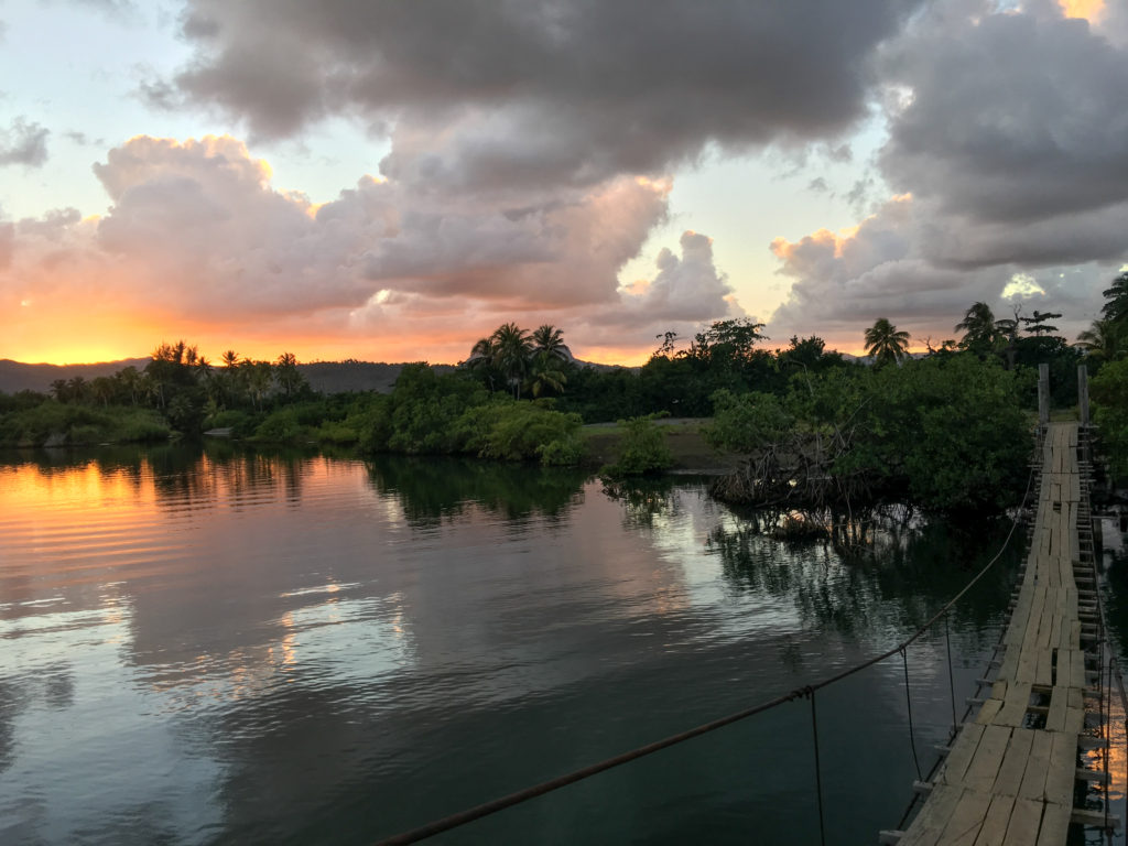 The sun sets over the swinging bridge in Baracoa.